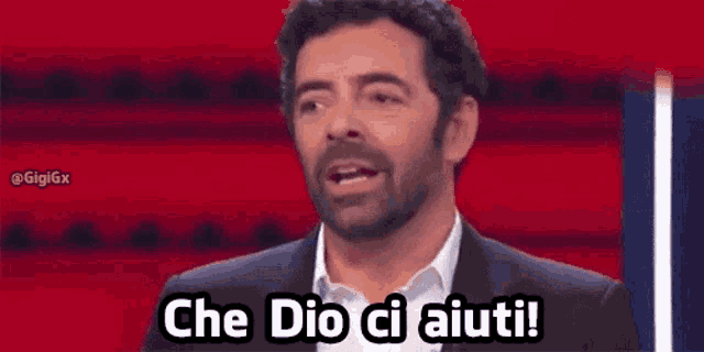 a man in a suit and white shirt is saying che dio ci aiuti