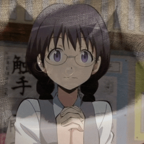 a girl with glasses and braids looks at the camera with chinese writing on the wall behind her