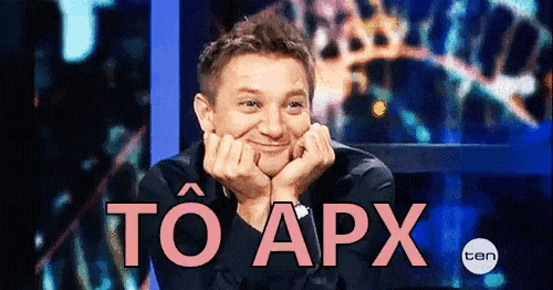 a man is sitting in front of a screen that says to apx