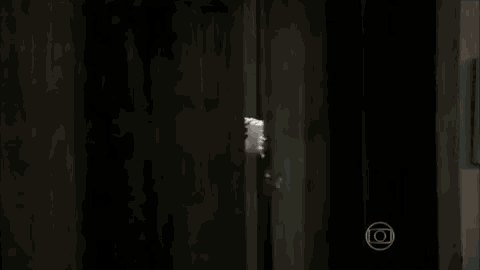 a woman in a bathrobe with a towel on her head is standing in a doorway .