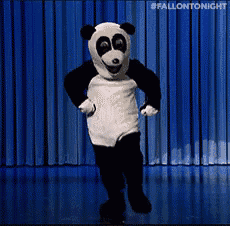 a panda mascot is dancing on a stage with a blue curtain behind him .