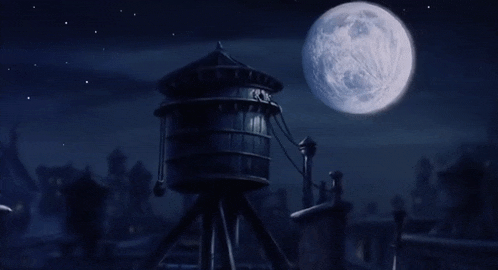 a water tower in the dark with a full moon behind it