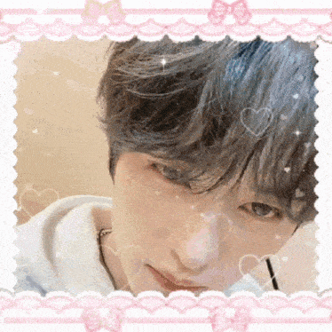 a close up of a person 's face in a pink frame with hearts and bows .