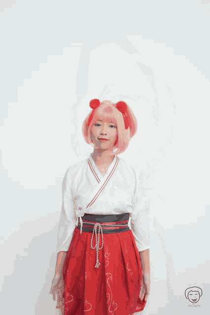a girl with pink hair is wearing a red skirt and a white shirt