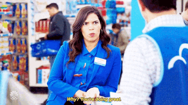 a woman in a blue jacket is talking to a man in a blue vest who is saying why you 're doing great