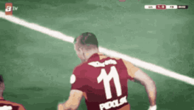 a soccer player with the number 11 on the back of his shirt