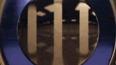 a close up of a circular object with arrows pointing up