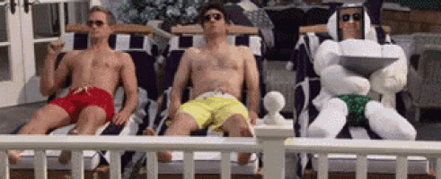 three men are sitting on lawn chairs on a deck .
