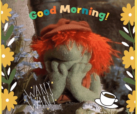 a green puppet with red hair says good morning