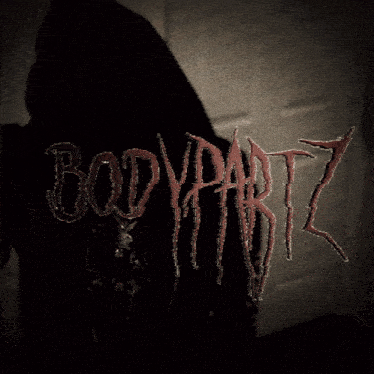 a person wearing a black hoodie with the word bodypartz embroidered on it