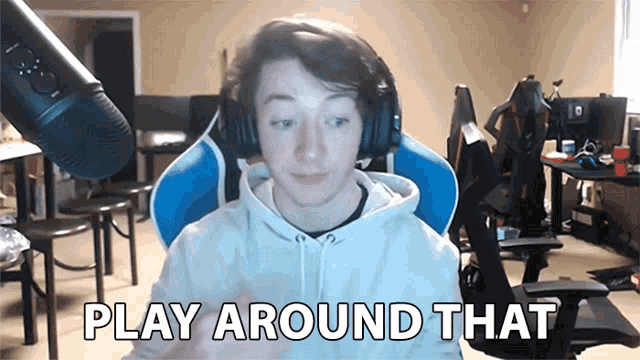 a man wearing headphones and a white hoodie says play around that