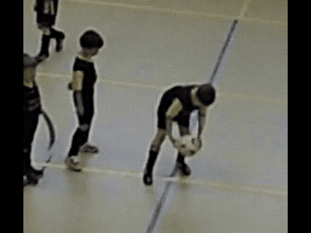a group of young boys are playing a game of soccer and one of them has the number 11 on his shirt