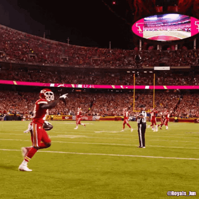a football game is being played in a stadium with a large screen that says royals_jim