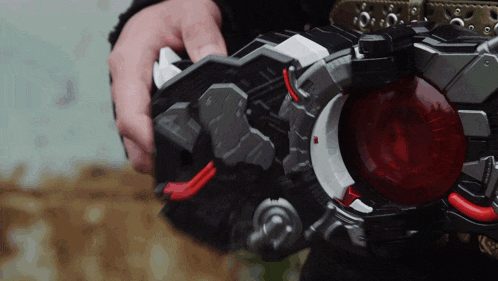 a close up of a person holding a toy that has a red circle on it