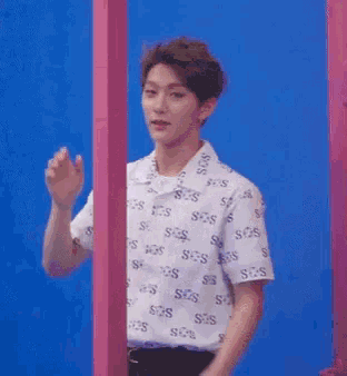 a man is holding a water gun in front of a door