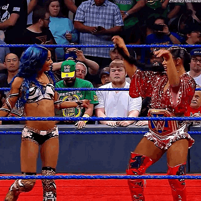 a man wearing a green shirt that says respect stands in a wrestling ring