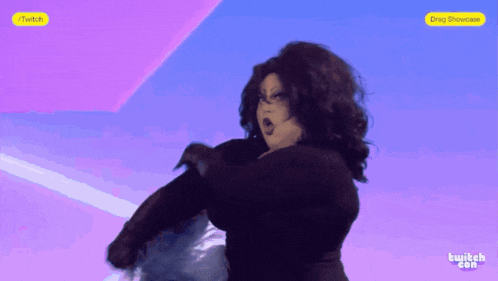 a drag queen is dancing on a screen that says twitch.com on the bottom