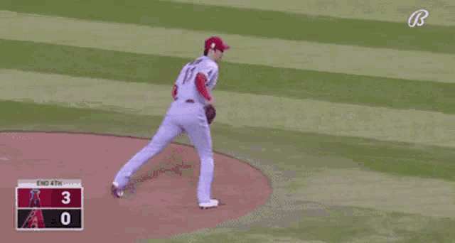 a baseball player with the number 17 on his jersey is walking on the field .
