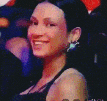 a close up of a woman 's face with a purple background .