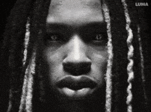 a black and white photo of a man with dreadlocks and the word luma on the bottom right