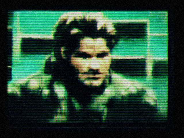 a tv screen shows a man with a beard and a green background