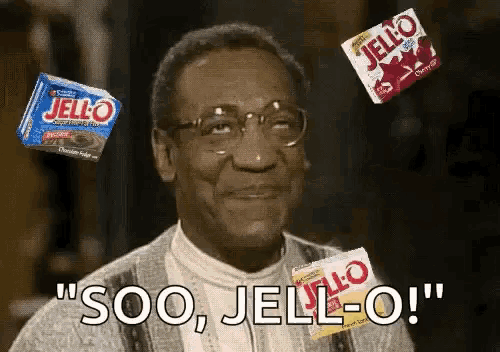 a man with glasses is surrounded by boxes of jello and says soo , jello-o !