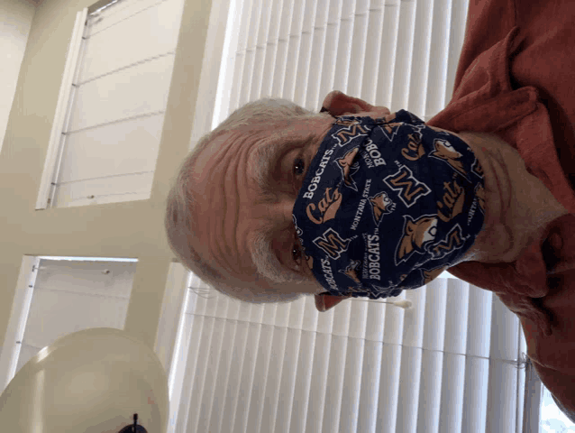 a man wearing a face mask that says bobcats