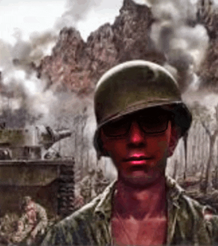 a man wearing a helmet and sunglasses is standing in front of a battle scene .