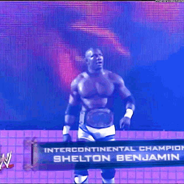 a man is standing in front of a sign that says ' intercontinental champion shelton benjamin '