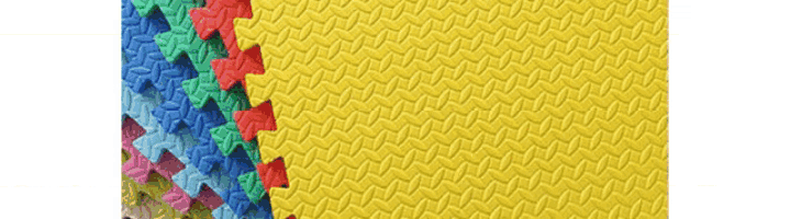 a close up of a yellow puzzle mat with a zig zag pattern