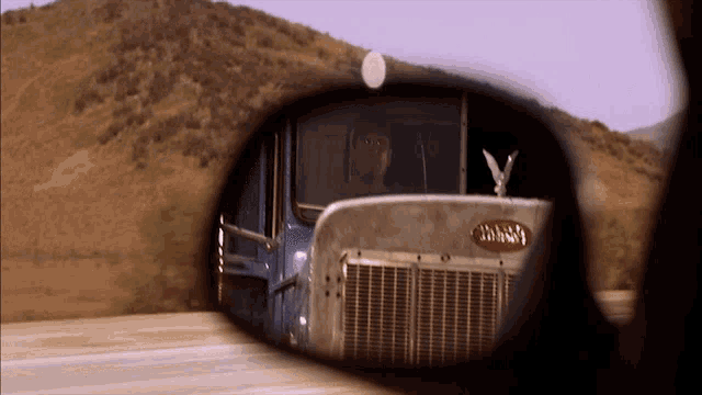 a peterbilt truck is reflected in the rear view mirror