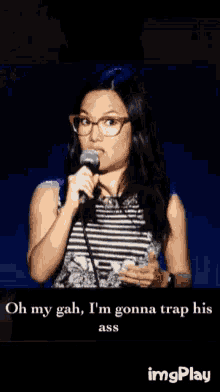 a woman with glasses is singing into a microphone with the words oh my gah i 'm gonna trap his ass below her