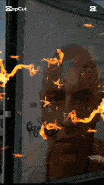 a picture of a man 's face with flames coming out of his eyes