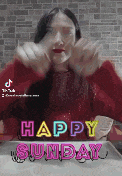 a woman in a red sweater is making a funny face and says happy sunday