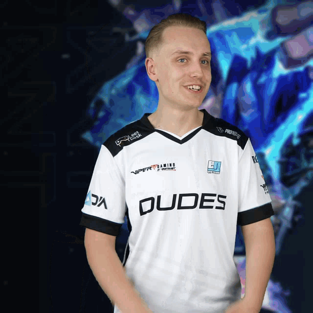 a man wearing a white shirt that says dudes on the front