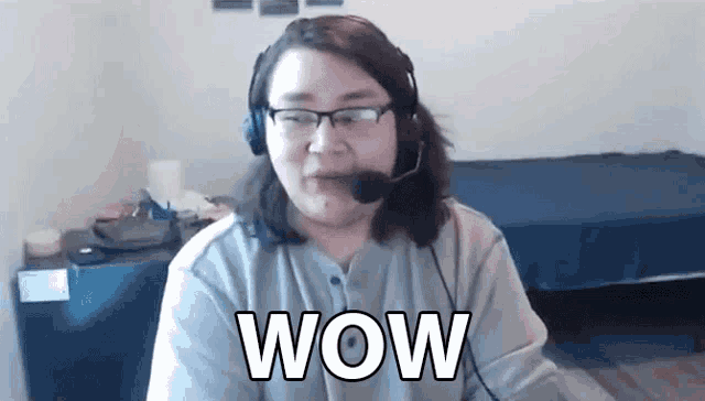 a woman wearing headphones and a microphone says wow