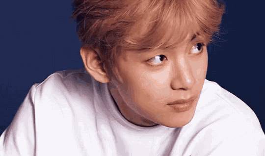a close up of a man 's face with a white shirt on