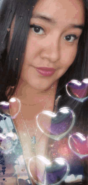 a woman surrounded by heart shaped bubbles looks at the camera