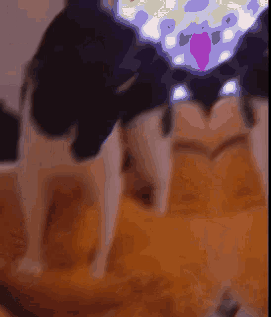 a blurred image of a cat with a purple heart on its chest
