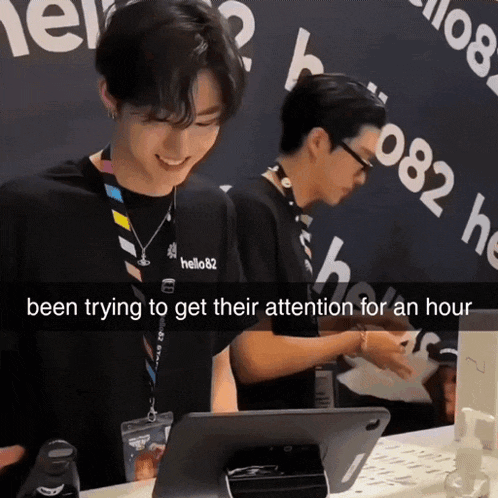 a man wearing a lanyard that says hello82 has been trying to get attention for an hour