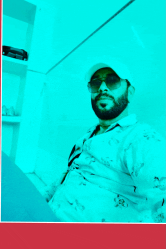 a man with a beard wearing a white hat and sunglasses