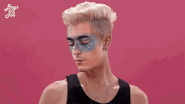 a man with his face painted and the words boys do n't joo behind him