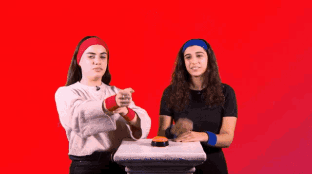 a woman wearing a red headband says burn in front of fire