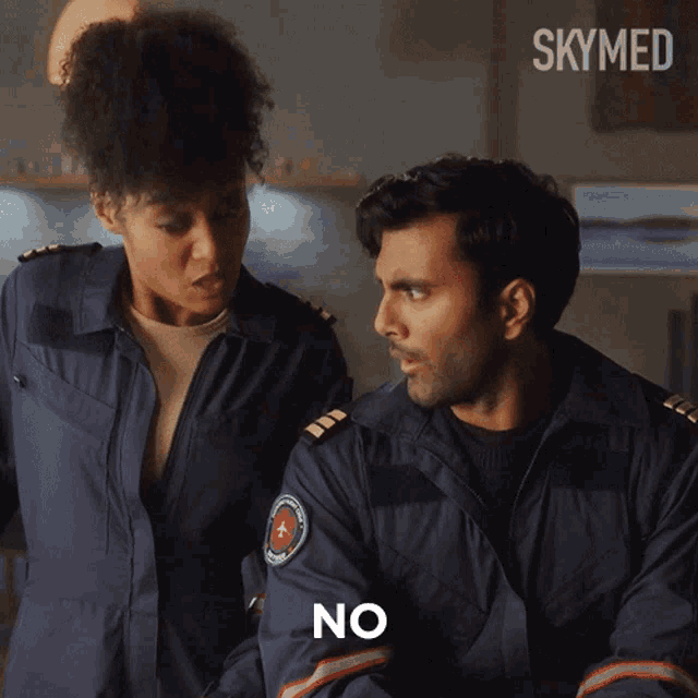 a man and a woman standing next to each other with the word no on the bottom right