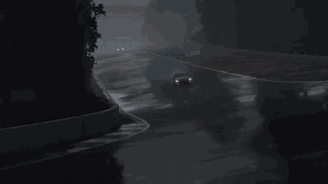 a red ford mustang is driving on a wet track