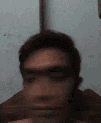 a blurry picture of a man 's face with a white background