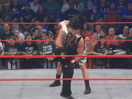 a wrestler wearing a shirt that says tome on it