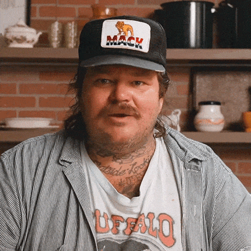 a man wearing a hat with mack on it