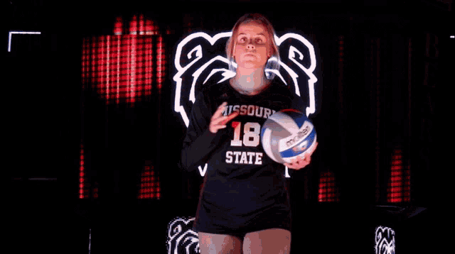missouri state player number 18 holds a volleyball in her hands