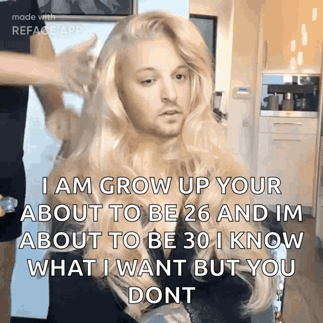 a man with blonde hair and a beard is getting his hair done by a hairdresser